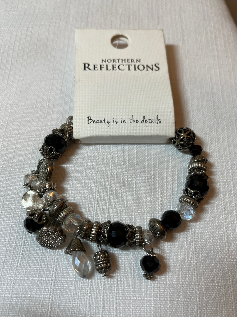 Northern Reflections Black and Clear Faceted Bead Charm Bracelet
NICKEL FREE